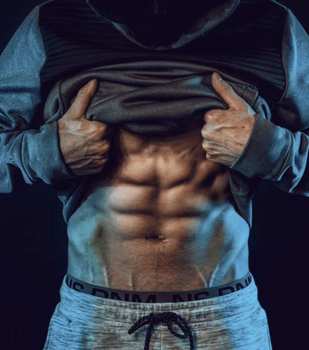 athlete with six pack abs showing his level of fitness